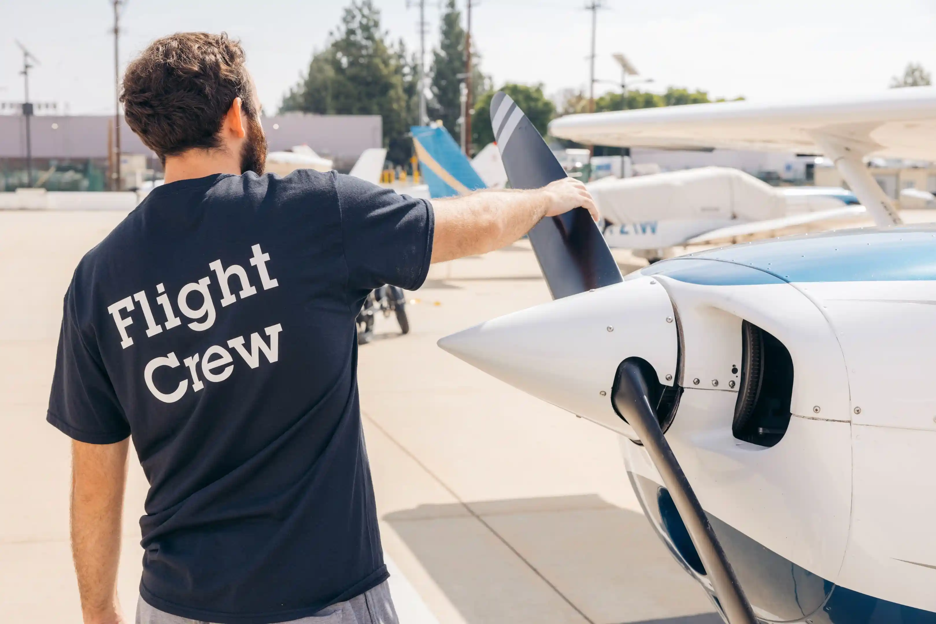 la flight academy los angeles flight school cfi checking propeller of piper archer plane