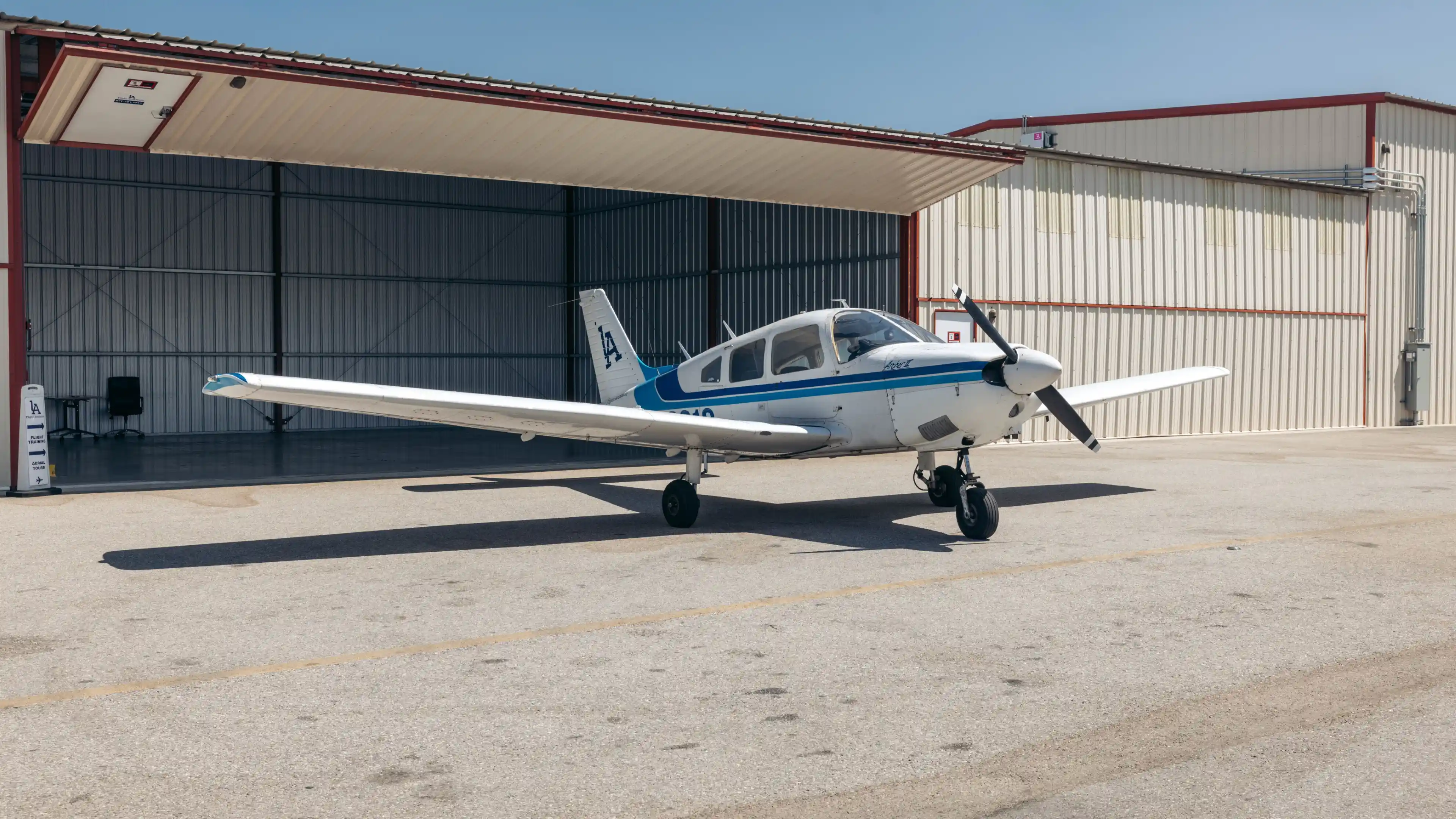 la flight academy los angeles flight school plane piper archer outside hangar