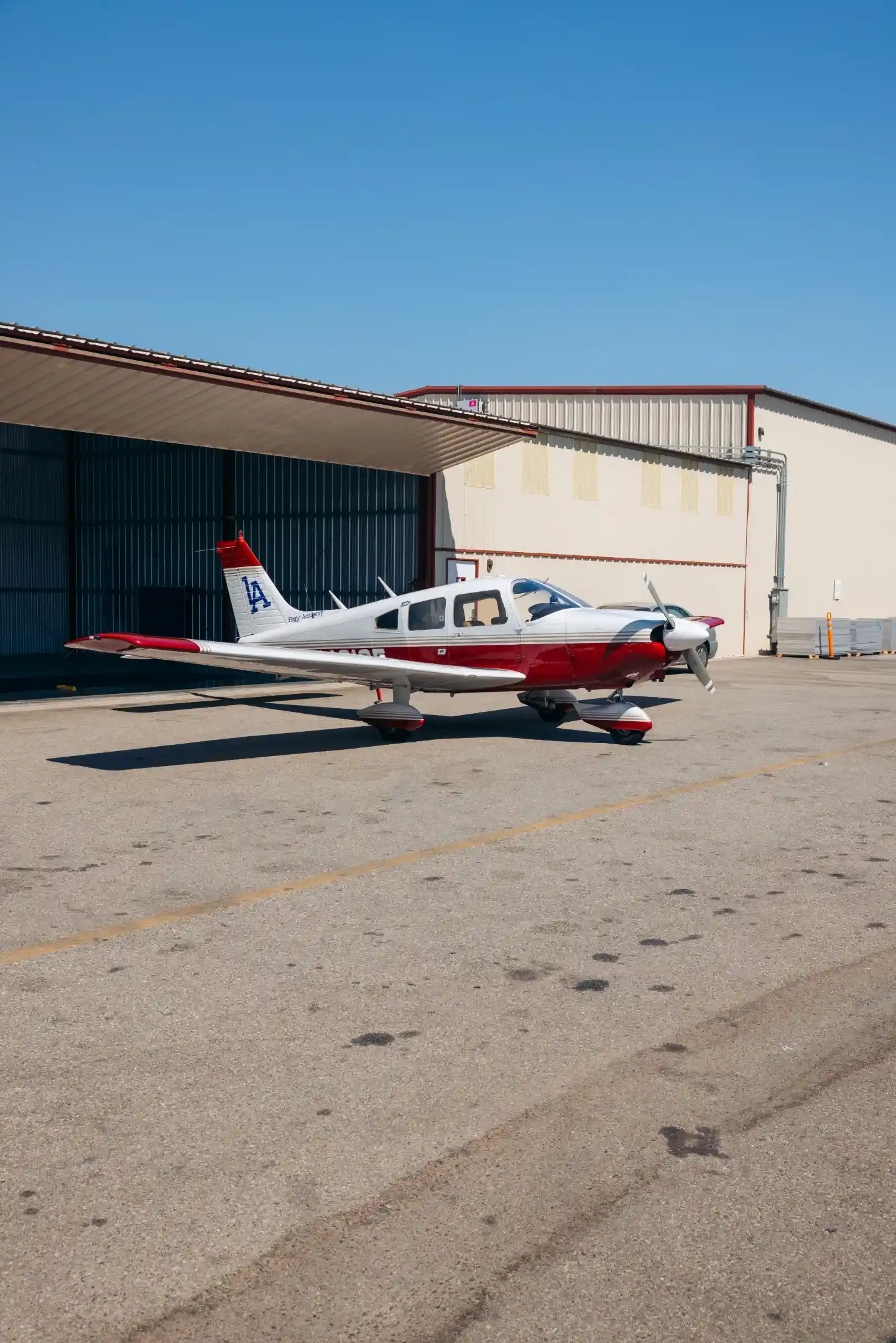 la flight academy los angeles flight school plane piper cherokee outside hangar 2