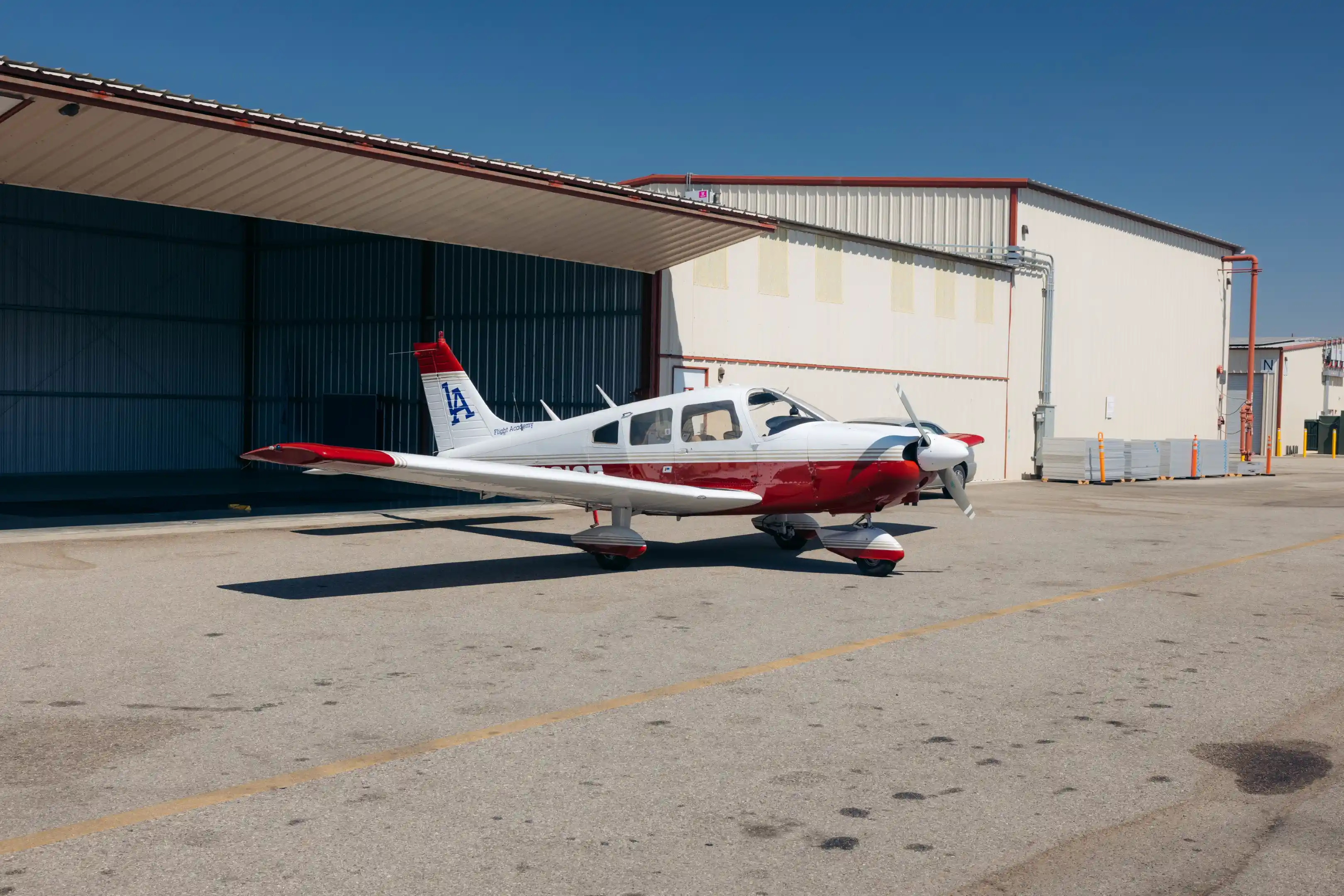 la flight academy los angeles flight school plane piper cherokee outside hangar