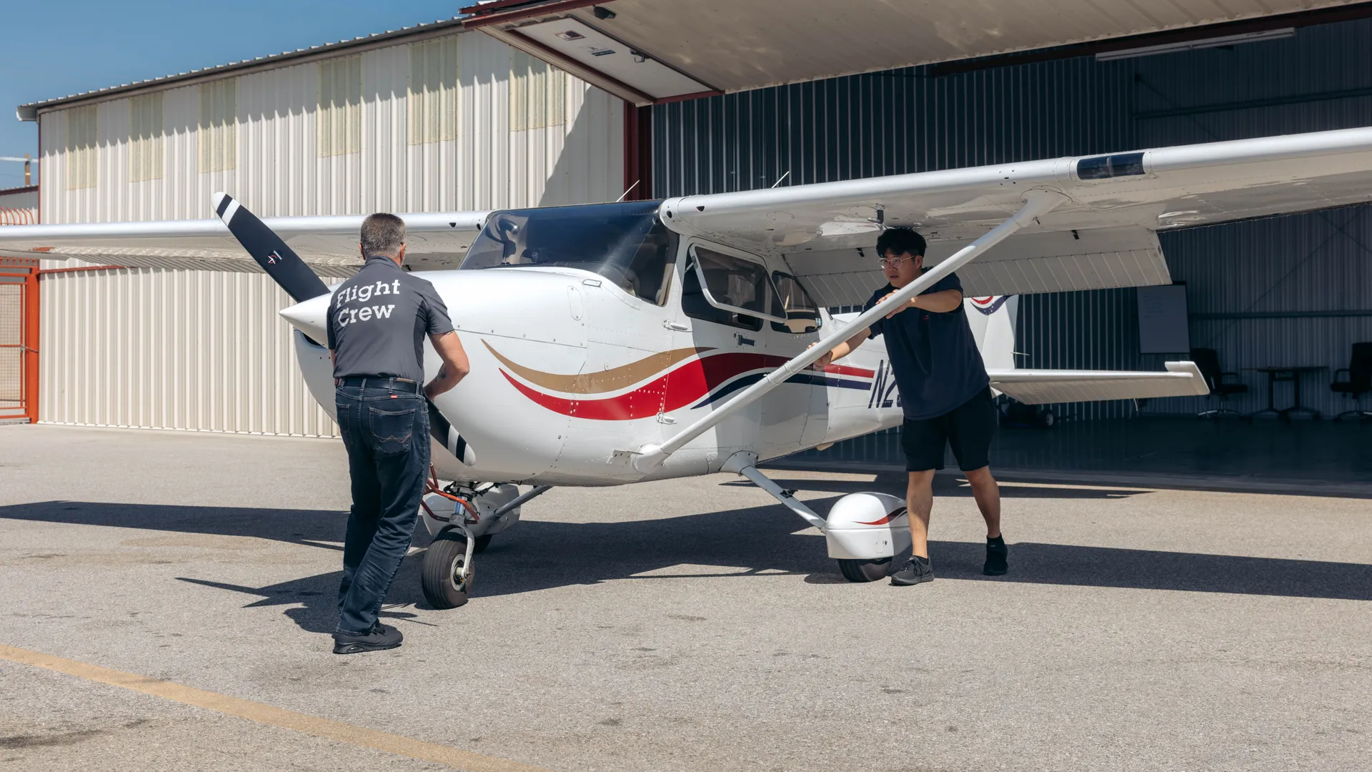 LA Flight Academy crew pulling plane from hangar