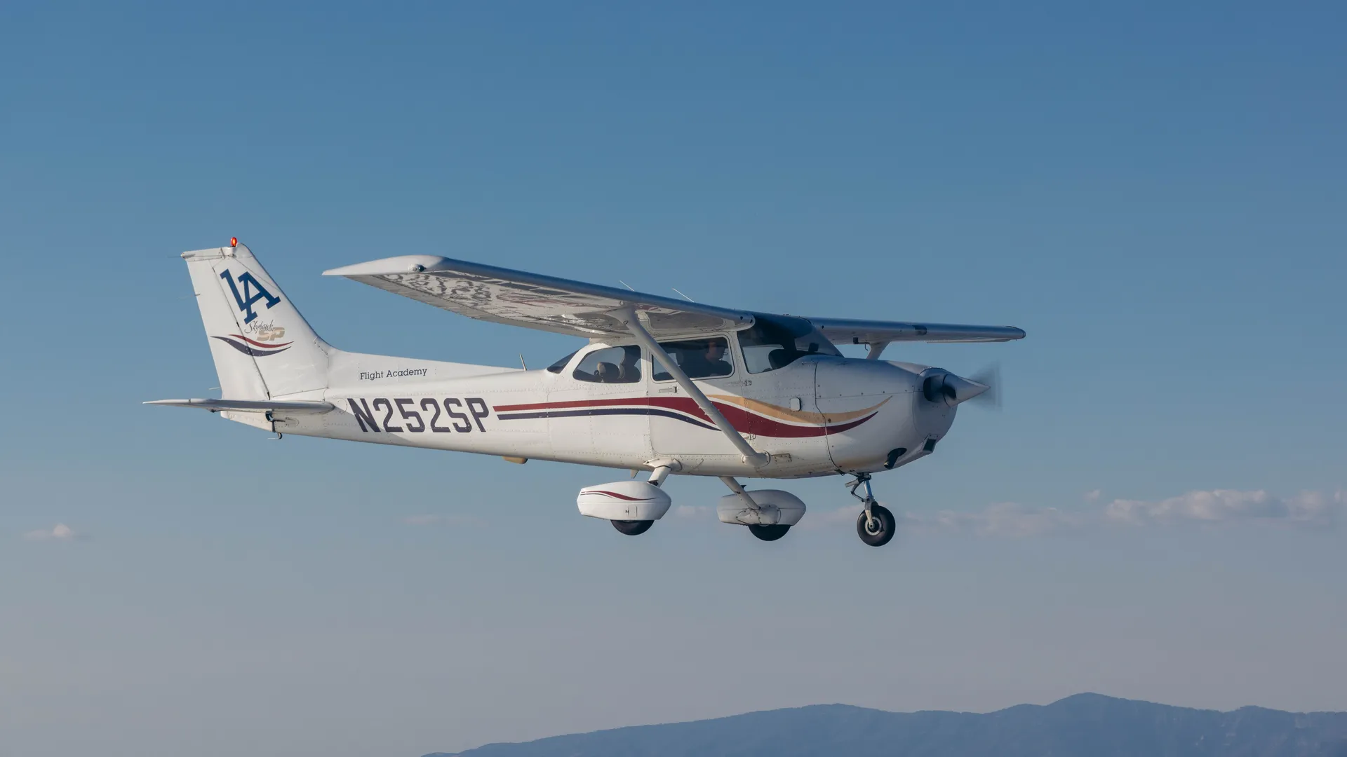 LA Flight Academy Cessna trainer aircraft flying over Southern California