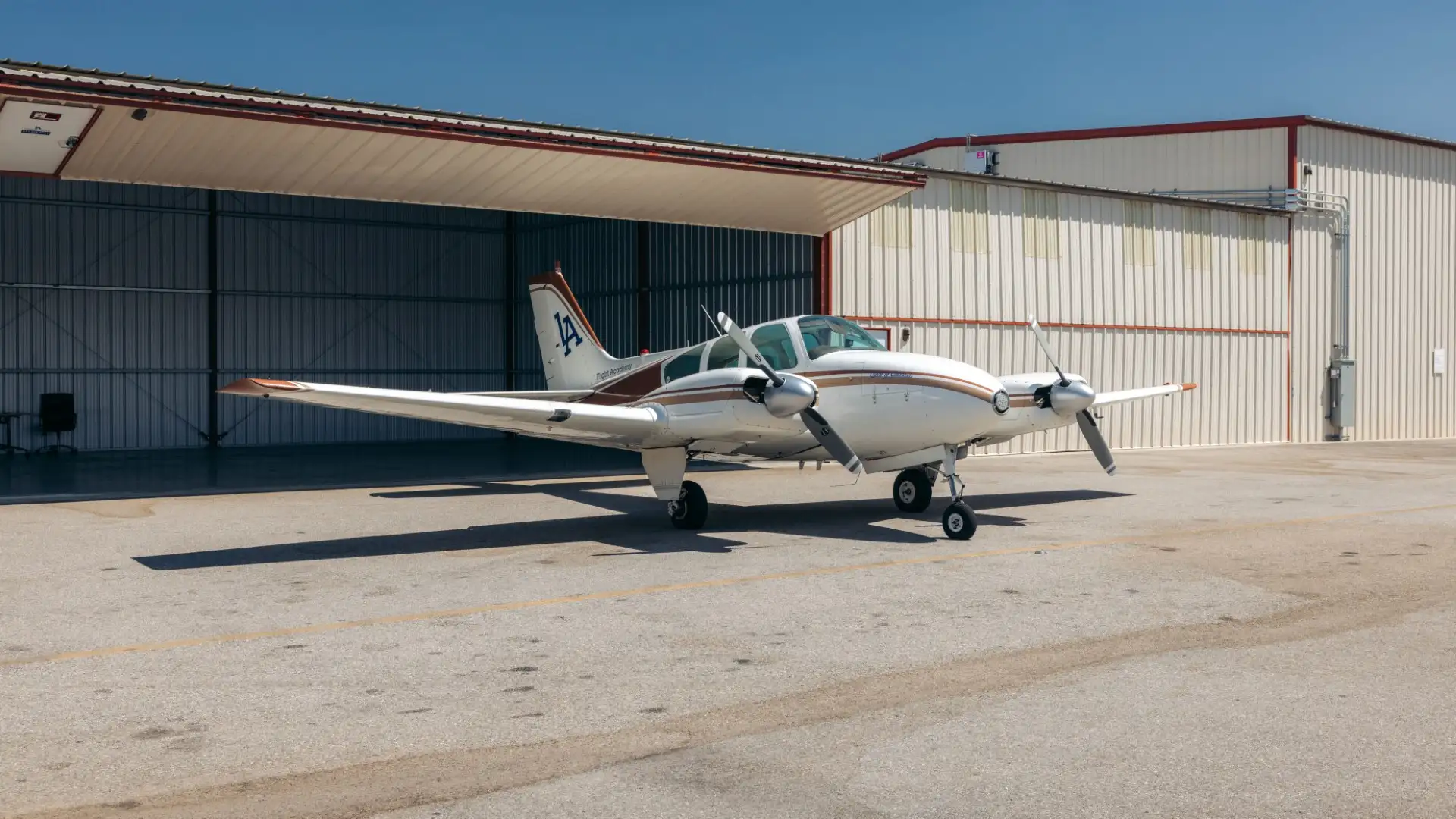 LAFA plane, Beechcraft Twin-Engine outside hangar at KVNY