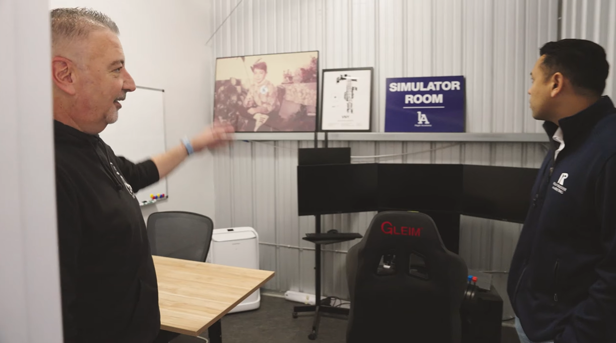 LA Flight Academy founder Anthony showing Tim Jedrek the simulator room during the America's Best Flight Schools episode