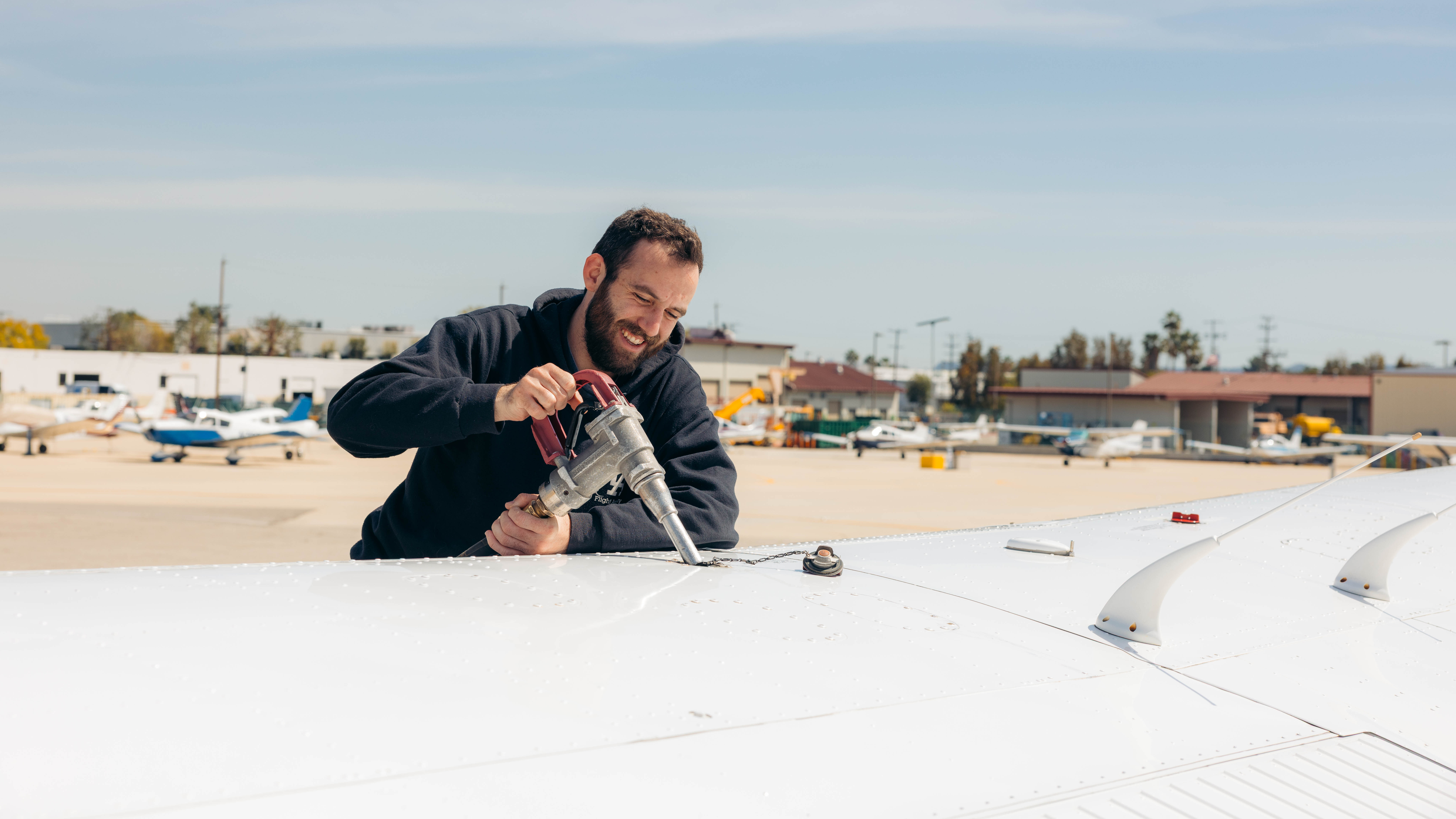 Fueling the wing tank of a training airplane on the ramp at Van Nuys Airport
