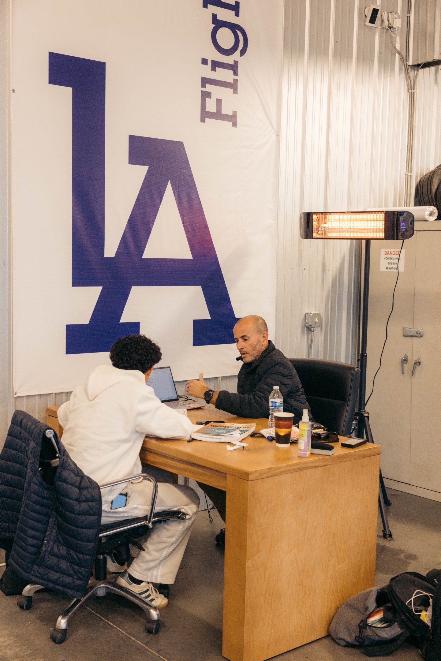 An enrollment specialist explaining pilot training path requirements to a new student pilot