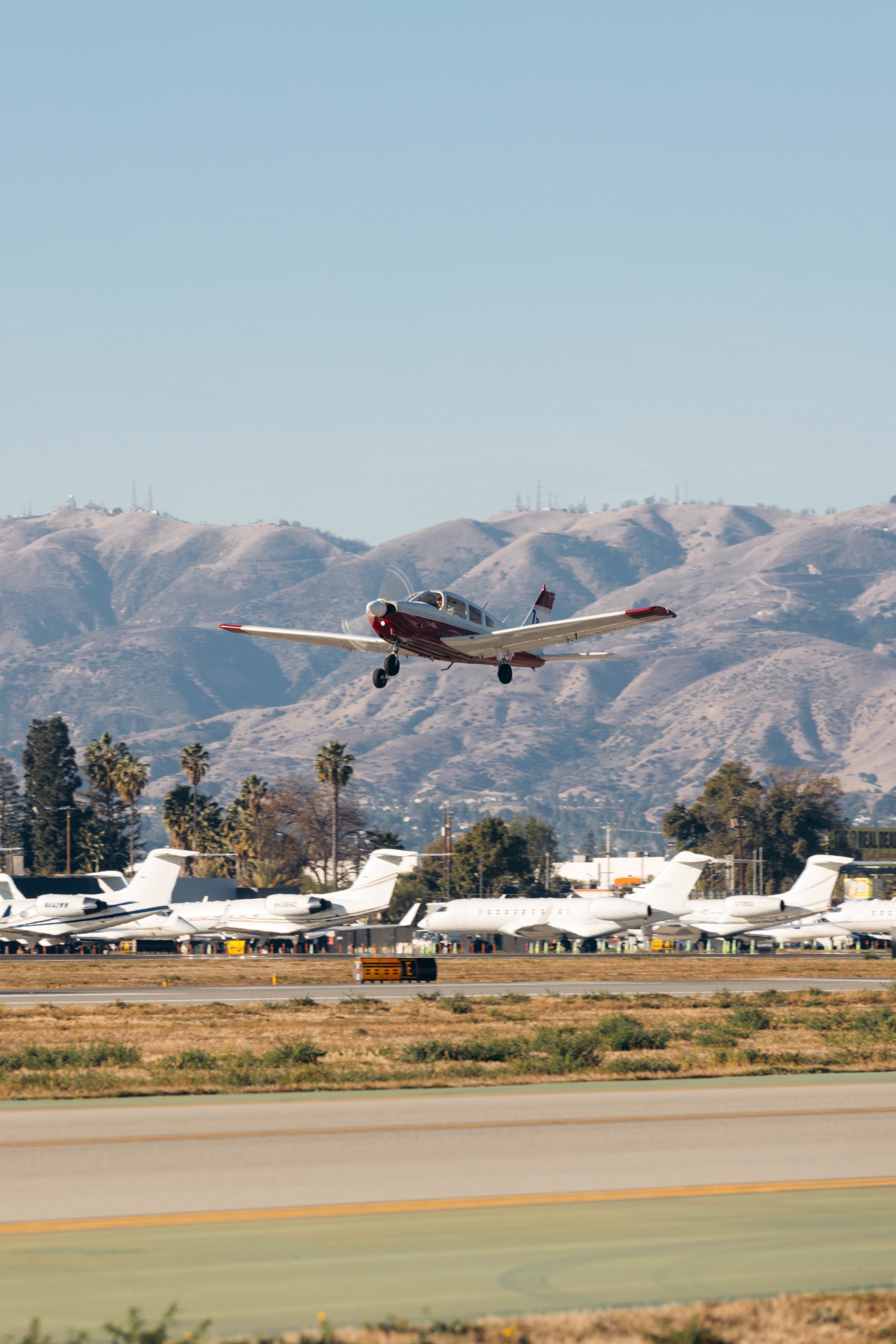 Piper training aircraft lifting off the runway at Van Nuys Airport